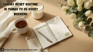 A cosy Sunday morning setup with an open weekly planner, a lit candle, herbal tea, and fresh flowers on a wooden table.